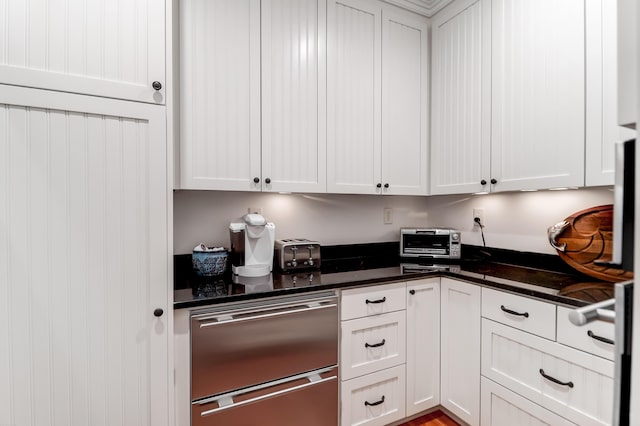 932 Middle St, Sullivans Island, SC 29482 - kitchen with dark countertops, dishwasher, and white cabinets