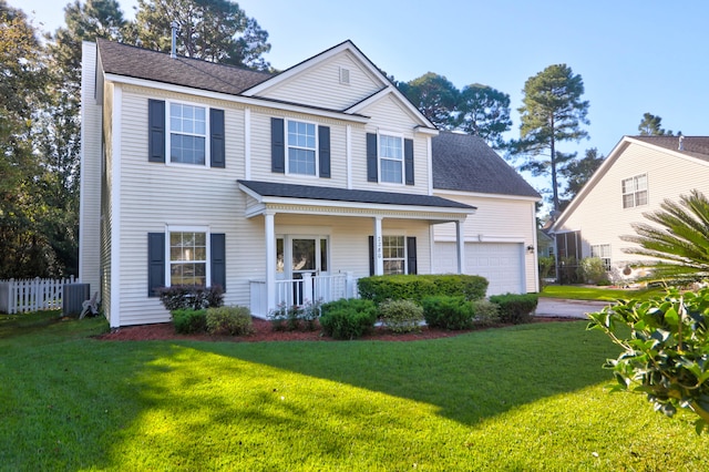 view of front of property featuring covered porch, a garage, and a front lawn