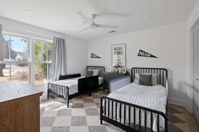 bedroom with visible vents, ceiling fan, and baseboards