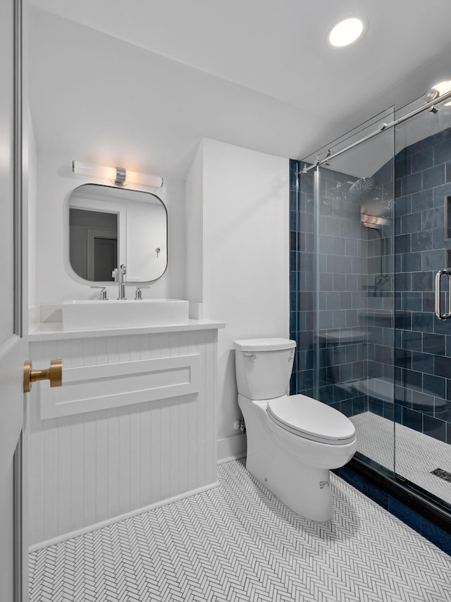 full bathroom featuring a stall shower, tile patterned flooring, vanity, and toilet