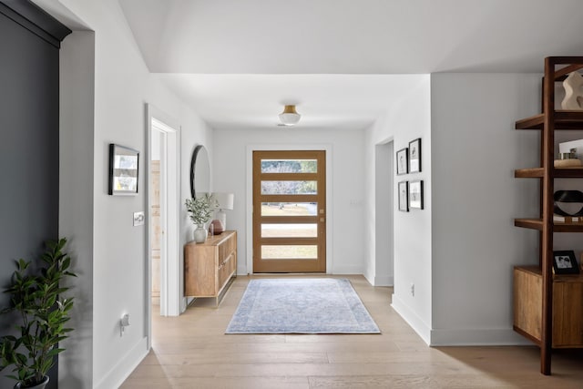 foyer featuring light wood-type flooring and baseboards