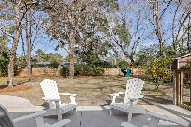 view of patio with a fenced backyard and a playground