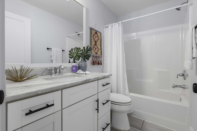 bathroom featuring toilet, vanity, and shower / bath combination with curtain