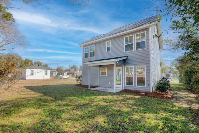 rear view of property with a patio and a yard