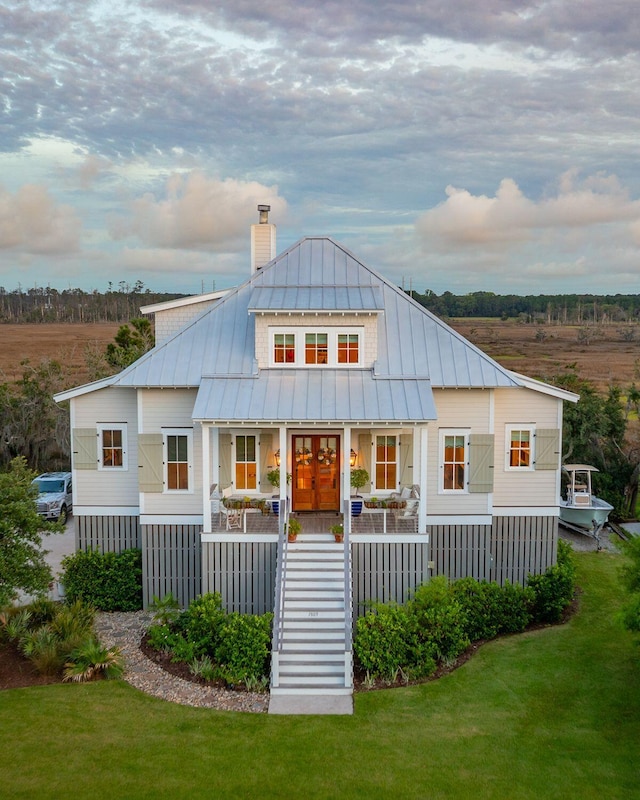 1809 Rushland Grove Ln, Johns Island, SC 29455 - back of house with covered porch, stairway, a chimney, and a yard