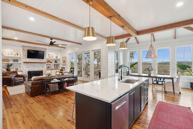1809 Rushland Grove Ln, Johns Island, SC 29455 - kitchen featuring light wood-style flooring, a large fireplace, beamed ceiling, ceiling fan, and pendant lighting