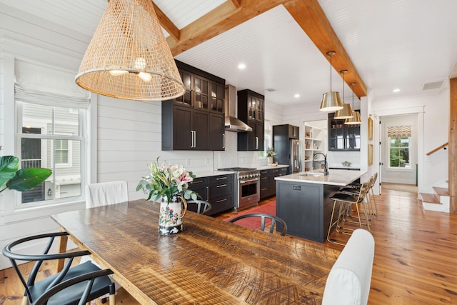 1809 Rushland Grove Ln, Johns Island, SC 29455 - kitchen with appliances with stainless steel finishes, beamed ceiling, a kitchen breakfast bar, light countertops, and light wood finished floors