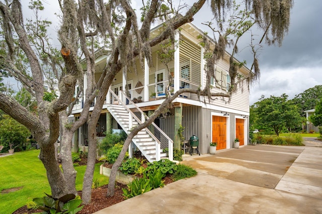 1809 Rushland Grove Ln, Johns Island, SC 29455 - view of front of house with driveway, an attached garage, stairway, covered porch, and a front yard