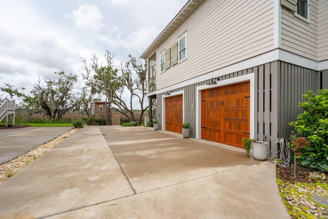 1809 Rushland Grove Ln, Johns Island, SC 29455 - view of side of property featuring board and batten siding, a garage, stairs, and driveway