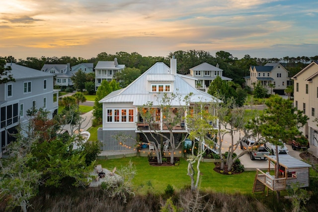 1809 Rushland Grove Ln, Johns Island, SC 29455 - rear view of property with a chimney, a residential view, a metal roof, a lawn, and a standing seam roof