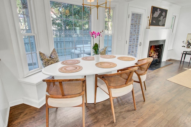 dining room featuring wood-type flooring and an inviting chandelier