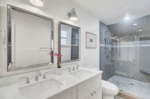 bathroom featuring vanity, toilet, and walk in shower