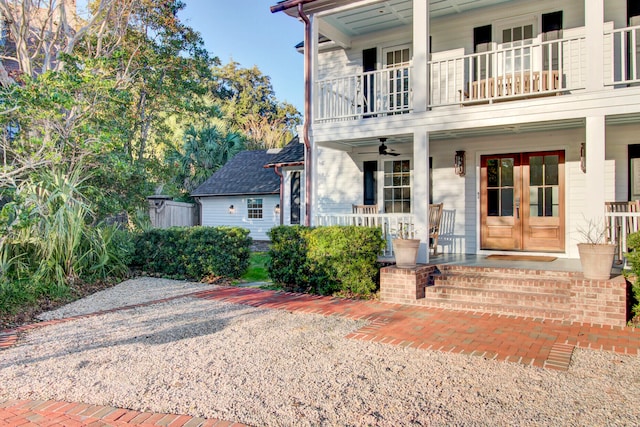 view of front facade featuring covered porch, french doors, a balcony, and ceiling fan