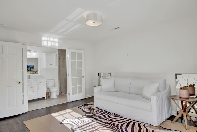 living room featuring french doors and dark wood-type flooring