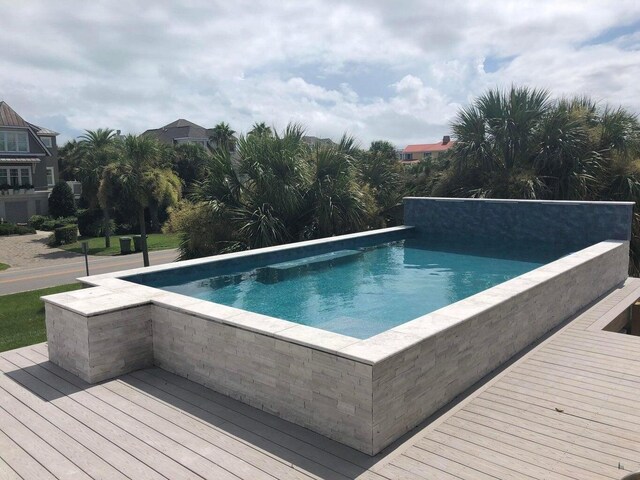 view of pool with a wooden deck