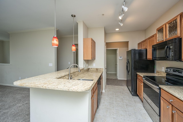 kitchen featuring light stone counters, brown cabinets, black appliances, glass insert cabinets, and pendant lighting