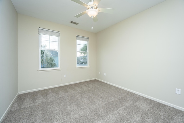 unfurnished room with ceiling fan, carpet, visible vents, and baseboards