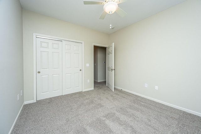 unfurnished bedroom with baseboards, a closet, a ceiling fan, and light colored carpet