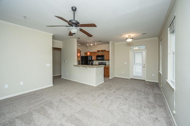 unfurnished living room with baseboards, a ceiling fan, light colored carpet, and crown molding