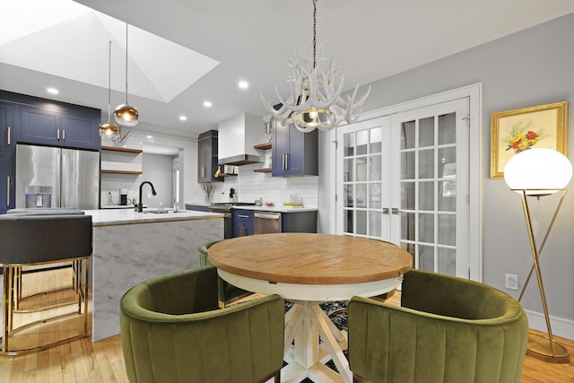2605 Mona Ave, Charleston, SC 29414 - dining space featuring light wood finished floors, a chandelier, recessed lighting, french doors, and baseboards