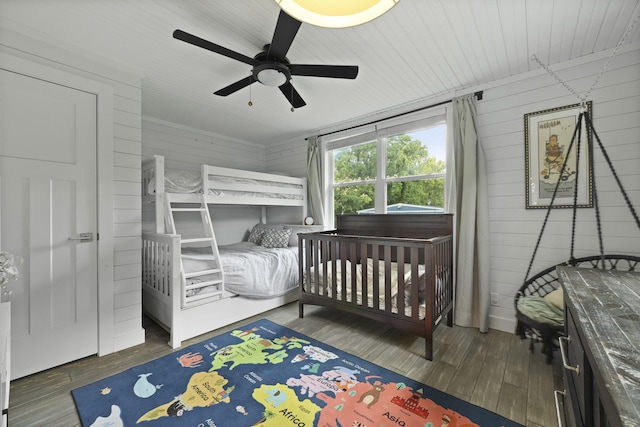 2605 Mona Ave, Charleston, SC 29414 - bedroom with wood finished floors, wooden walls, and a ceiling fan