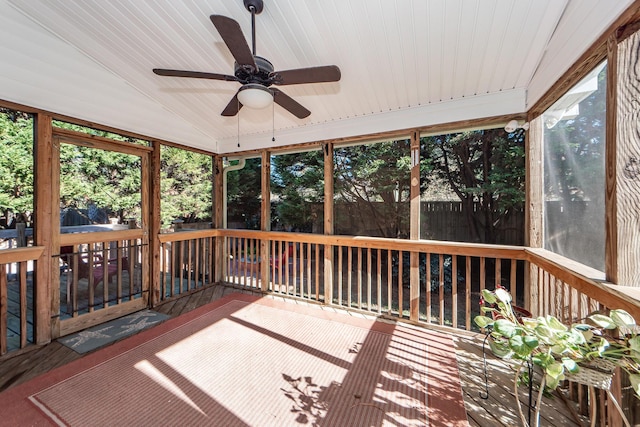 unfurnished sunroom featuring a wealth of natural light, ceiling fan, and vaulted ceiling