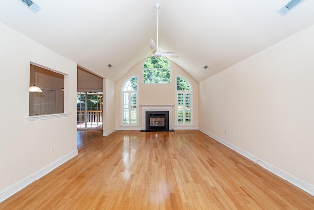 unfurnished living room with high vaulted ceiling, light hardwood / wood-style floors, and ceiling fan