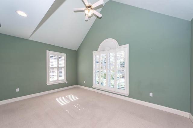 unfurnished room with ceiling fan, light colored carpet, and high vaulted ceiling