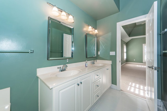 bathroom featuring lofted ceiling and vanity