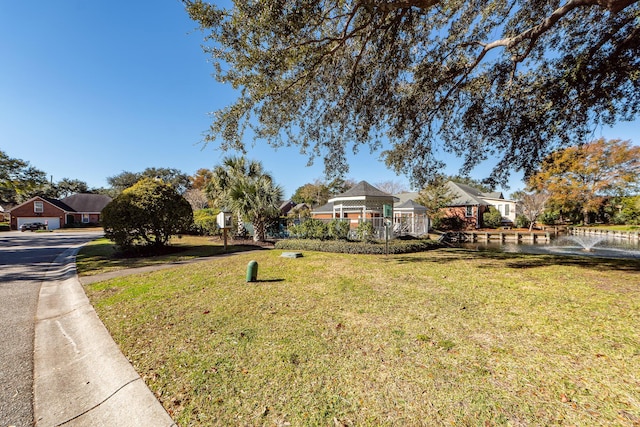 view of front of property featuring a gazebo and a front yard