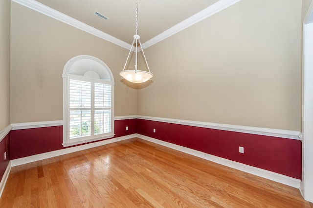 unfurnished room with crown molding and hardwood / wood-style floors