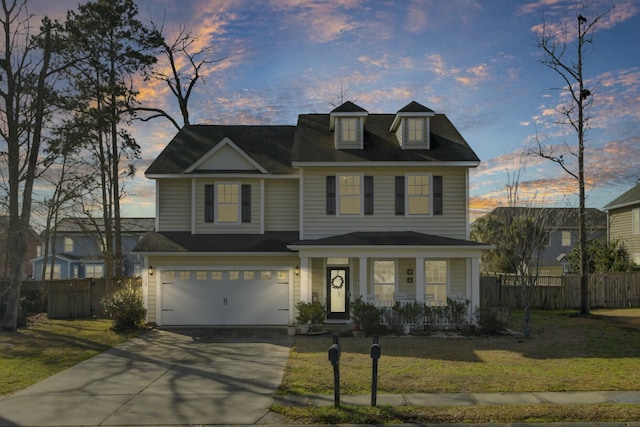 view of front of property with a lawn, concrete driveway, an attached garage, fence, and a porch