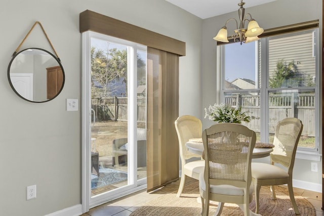 dining space featuring baseboards, light tile patterned flooring, and a notable chandelier