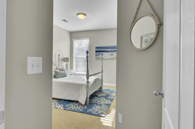 carpeted bedroom with visible vents and baseboards