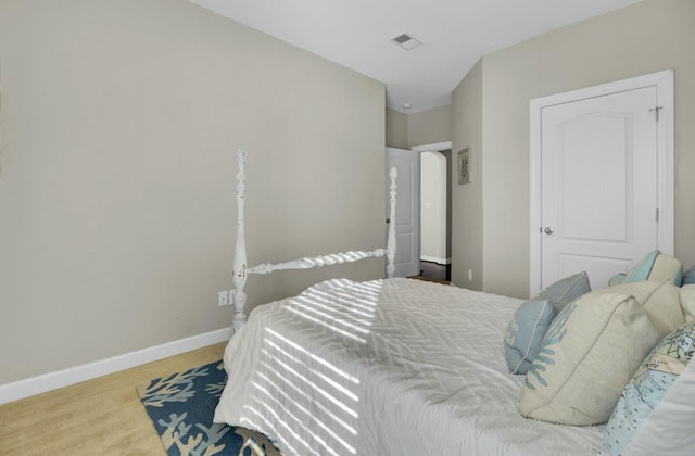 bedroom featuring baseboards and visible vents