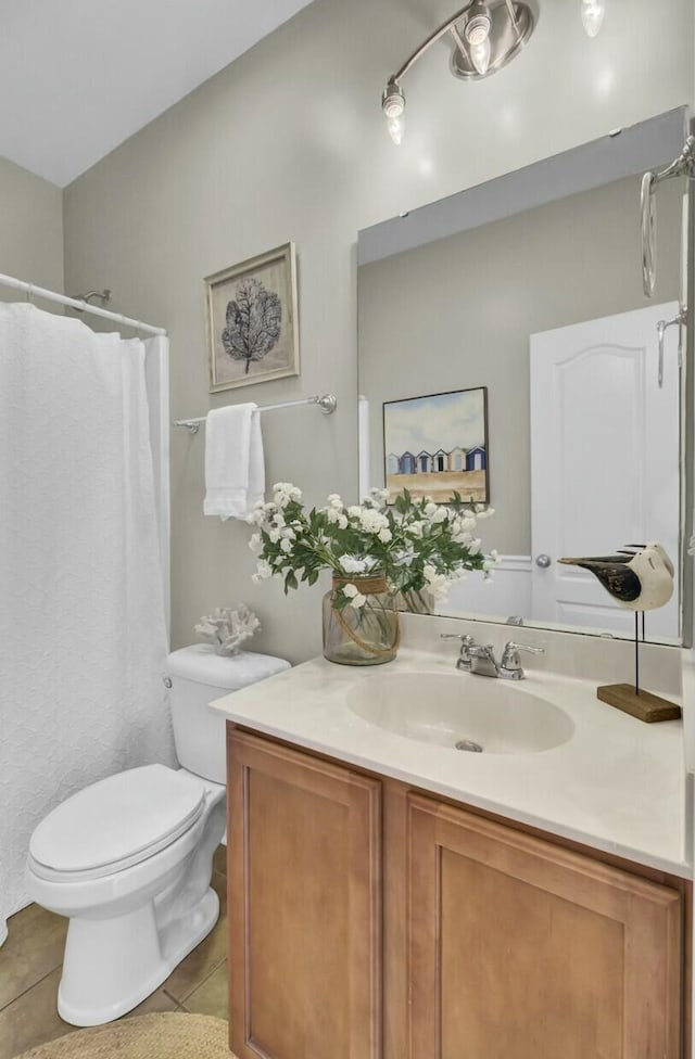 bathroom with toilet, tile patterned flooring, vanity, and a shower with curtain