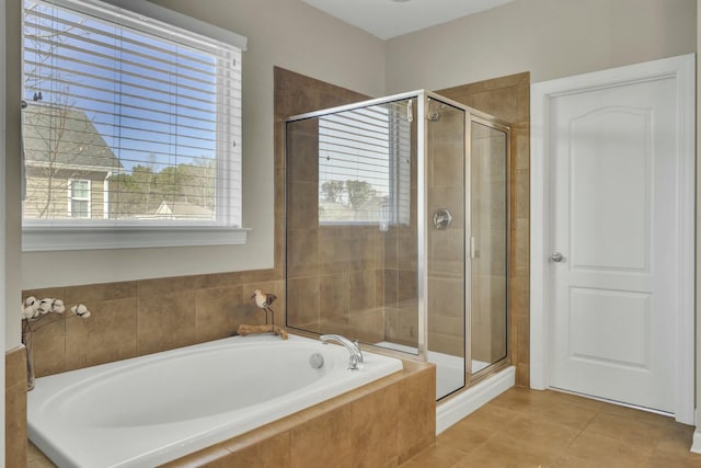 full bath featuring a stall shower, tile patterned flooring, and a garden tub