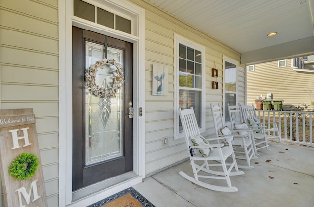 entrance to property with covered porch and visible vents