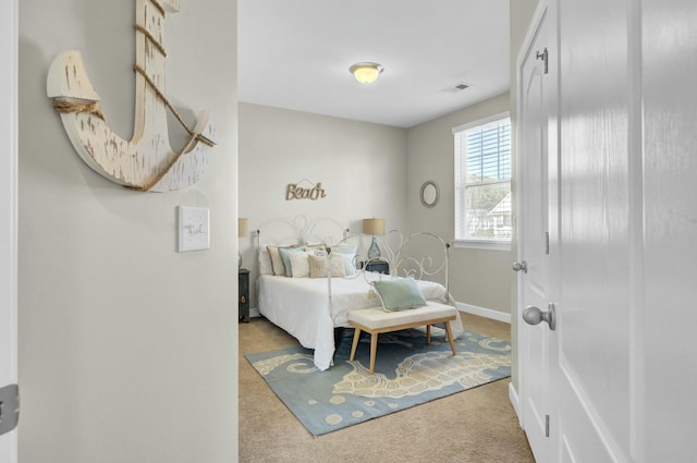 carpeted bedroom featuring baseboards and visible vents