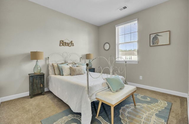 carpeted bedroom with visible vents and baseboards