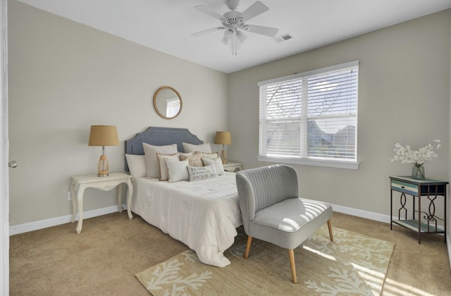 bedroom with light carpet, baseboards, visible vents, and a ceiling fan