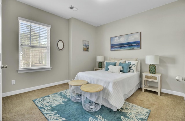 carpeted bedroom featuring visible vents and baseboards