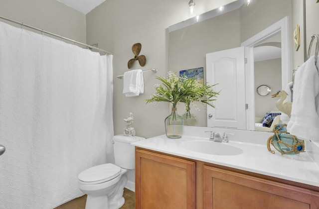 bathroom featuring vanity, toilet, and tile patterned floors