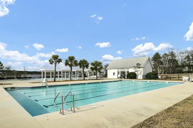 pool with fence and a patio