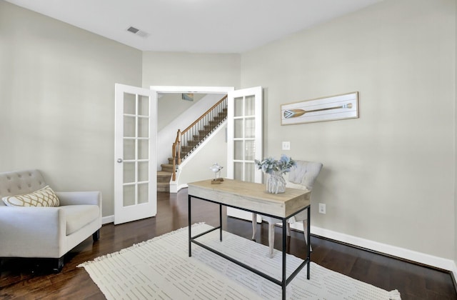 office with french doors, visible vents, baseboards, and wood finished floors