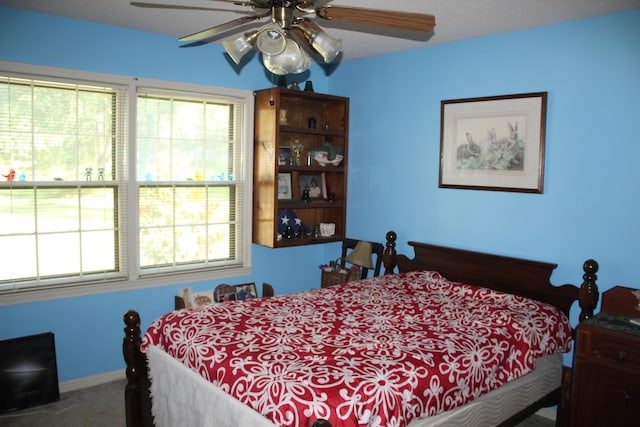 bedroom with carpet floors, baseboards, and a ceiling fan