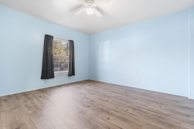 spare room with light wood-style floors and a ceiling fan