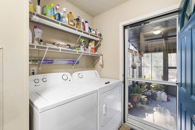 laundry room featuring washing machine and dryer, laundry area, and a textured ceiling
