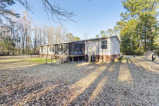 manufactured / mobile home with a sunroom and fence
