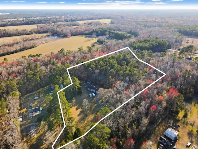 aerial view featuring a rural view and a wooded view